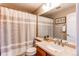 Bathroom featuring a single sink vanity, decorative mirror and medicine cabinet at 10109 W Fremont Ave, Littleton, CO 80127