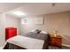 Bedroom featuring carpeted floors, a queen bed, side tables, and a red dresser at 10109 W Fremont Ave, Littleton, CO 80127