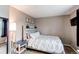 Cozy bedroom with neutral walls, a comfy bed, and a modern side table at 10109 W Fremont Ave, Littleton, CO 80127