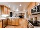 Modern kitchen featuring stainless steel appliances, light wood cabinets, and hardwood floors at 10109 W Fremont Ave, Littleton, CO 80127