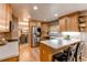Bright kitchen featuring stainless steel appliances, light wood cabinets, and a breakfast bar at 10109 W Fremont Ave, Littleton, CO 80127