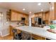 Spacious kitchen featuring stainless steel appliances, light wood cabinets, and a breakfast bar at 10109 W Fremont Ave, Littleton, CO 80127