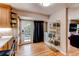 Bright eat-in kitchen with access to the deck featuring light wood cabinets and hardwood floors at 10109 W Fremont Ave, Littleton, CO 80127