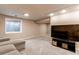 Bright living room area complete with plush gray carpet, a flat-screen TV, and ample space at 10109 W Fremont Ave, Littleton, CO 80127