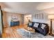Cozy living room featuring hardwood floors, a comfortable sofa, and stylish decor at 10109 W Fremont Ave, Littleton, CO 80127