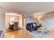 Open-concept living and dining area featuring hardwood floors and comfortable furnishings at 10109 W Fremont Ave, Littleton, CO 80127