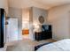Bedroom with a glimpse into the ensuite bathroom, with warm lighting at 10109 W Fremont Ave, Littleton, CO 80127
