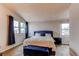 Bright main bedroom with large windows, a comfortable bed, and stylish blue accents at 10109 W Fremont Ave, Littleton, CO 80127