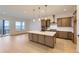 Modern kitchen with stainless steel appliances, a large island, and pendant lighting at 231 Leafy Aster Ln, Castle Rock, CO 80104