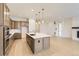 Modern kitchen with stainless steel appliances, a large island, and pendant lighting at 231 Leafy Aster Ln, Castle Rock, CO 80104