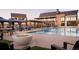 Community pool featuring a fire pit and lounge chairs with a nearby clubhouse at 231 Leafy Aster Ln, Castle Rock, CO 80104