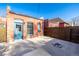 Cozy backyard featuring a firepit, brick building, and a fence at 561 Cherokee St, Denver, CO 80204