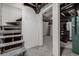 Unfinished basement with exposed ductwork, stairs, and doorway at 561 Cherokee St, Denver, CO 80204
