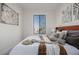 Well-lit bedroom featuring decoratively appointed bed, large window and modern art at 561 Cherokee St, Denver, CO 80204