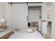 Bedroom featuring a large sliding barn door, closet, and decorative accents at 561 Cherokee St, Denver, CO 80204