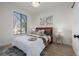 Cozy bedroom featuring a comfortable bed, modern artwork, and a large window at 561 Cherokee St, Denver, CO 80204