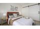 Stylish bedroom with a sliding barn door, accent tables, modern art, and natural light at 561 Cherokee St, Denver, CO 80204