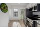 Bright kitchen features stainless appliances and a glass paneled door to the exterior at 561 Cherokee St, Denver, CO 80204