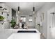 Modern kitchen island with a black sink, sleek pendant lights, and decoratively set dining table at 561 Cherokee St, Denver, CO 80204