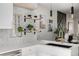 Modern kitchen with white countertops, stylish backsplash, floating shelves, and stainless steel sink at 561 Cherokee St, Denver, CO 80204