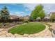 Beautifully landscaped backyard with stone pathway and manicured green space at 6520 S Newcastle Way, Aurora, CO 80016
