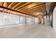 Unfinished basement with exposed ceiling, concrete floors and small windows providing natural light at 6520 S Newcastle Way, Aurora, CO 80016
