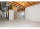Unfinished basement featuring a stairway entrance and an egress window at 6520 S Newcastle Way, Aurora, CO 80016