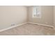 Clean, empty bedroom with neutral carpet and a window, ready for personalization at 6520 S Newcastle Way, Aurora, CO 80016