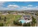 Aerial shot of community amenities including a pool, playground, and green spaces near residential homes at 6520 S Newcastle Way, Aurora, CO 80016