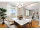 Bright dining room with a marble table, a large window with curtains, and hardwood flooring at 6520 S Newcastle Way, Aurora, CO 80016