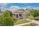 Charming single-Gathering home with stone accents, landscaped front yard and covered porch at 6520 S Newcastle Way, Aurora, CO 80016