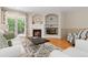Comfortable living room with a fireplace, a cozy armchair, and sliding glass doors for ample light at 6520 S Newcastle Way, Aurora, CO 80016
