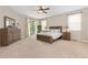 Bright main bedroom boasts a ceiling fan, lots of natural light, and carpeted floors at 6520 S Newcastle Way, Aurora, CO 80016