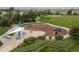 Aerial view of a neighborhood playground with covered picnic tables, slide, and play equipment at 6520 S Newcastle Way, Aurora, CO 80016
