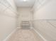 Carpeted walk-in closet equipped with white shelving units and hanging racks at 6520 S Newcastle Way, Aurora, CO 80016