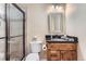 Well-lit bathroom with a glass-enclosed shower, vanity with granite countertop, and modern fixtures at 2716 Dundee Pl, Erie, CO 80516