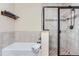 Modern bathroom featuring a combined shower and tub with bronze fixtures at 2716 Dundee Pl, Erie, CO 80516