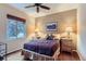Comfortable bedroom with a ceiling fan and large window with natural light at 2716 Dundee Pl, Erie, CO 80516