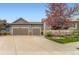 Home exterior showcasing the two-car garage, well-maintained lawn, and attractive curb appeal at 2716 Dundee Pl, Erie, CO 80516