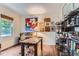 Cozy home office with hardwood floors, a wooden desk, and shelving for storage and decor at 2716 Dundee Pl, Erie, CO 80516