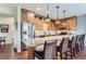 Well-lit kitchen featuring granite counters, wood cabinetry, and stainless steel appliances at 2716 Dundee Pl, Erie, CO 80516