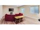 Cozy living room with a large television, comfortable seating, and natural light from the windows at 2716 Dundee Pl, Erie, CO 80516