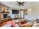 Comfortable living room featuring a brick fireplace and hardwood floors at 2716 Dundee Pl, Erie, CO 80516