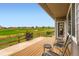 Outdoor patio with chairs overlooking a golf course with a beautiful view and privacy at 2716 Dundee Pl, Erie, CO 80516