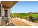 Outdoor patio with chairs overlooking a golf course and a beautiful view at 2716 Dundee Pl, Erie, CO 80516