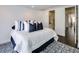 Bright bedroom with a white comforter and blue and white pillows at 52 Sedgwick Dr, Cherry Hills Village, CO 80113