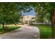 Curved driveway leads to a modern home with landscaped lawn at 52 Sedgwick Dr, Cherry Hills Village, CO 80113