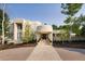 Modern home's entryway features a stone walkway and lush landscaping at 52 Sedgwick Dr, Cherry Hills Village, CO 80113