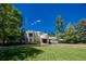 Contemporary home showcasing a manicured lawn and circular driveway at 52 Sedgwick Dr, Cherry Hills Village, CO 80113