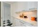 Well-lit laundry room with ample counter space and white cabinetry at 52 Sedgwick Dr, Cherry Hills Village, CO 80113